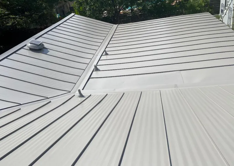 Solar attic fan installed on a metal roof for Roof Ventilation in Kankakee